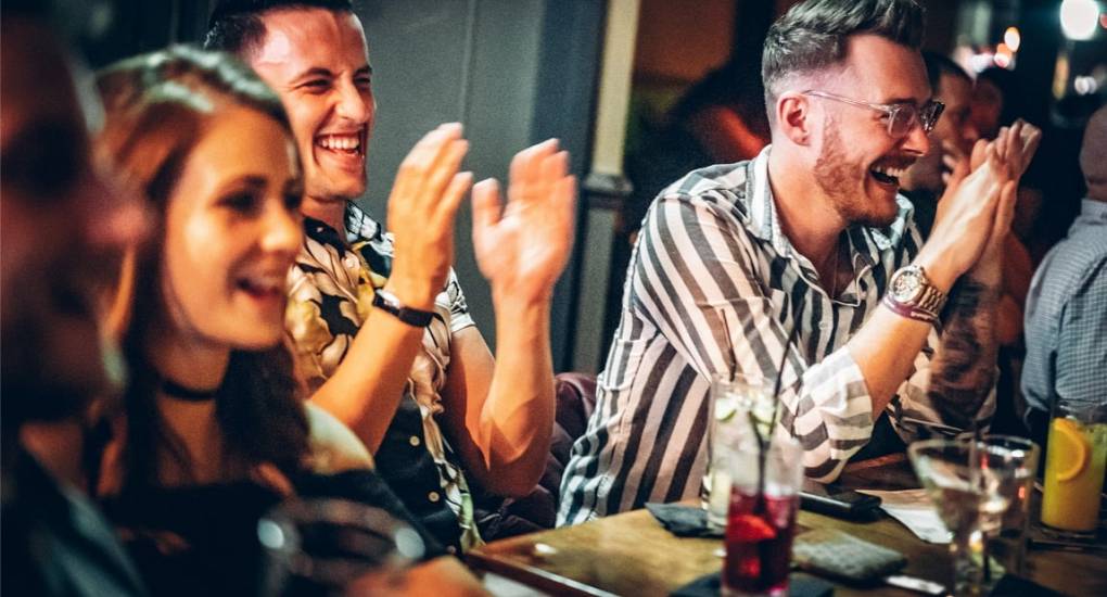 Partygoers enjoying a comedy night