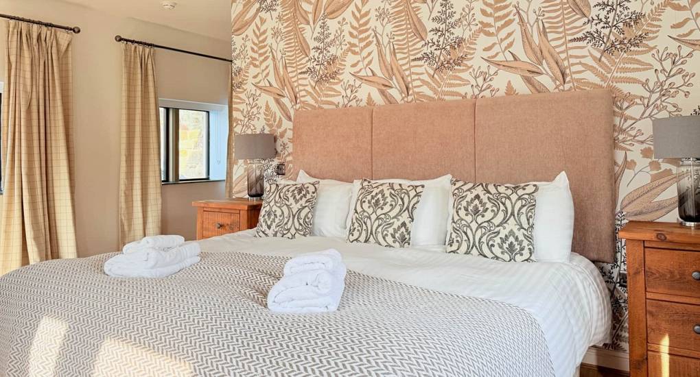 Master bedroom with Emperor bed at Godfrey Manor, a luxury Peak District hen party house.