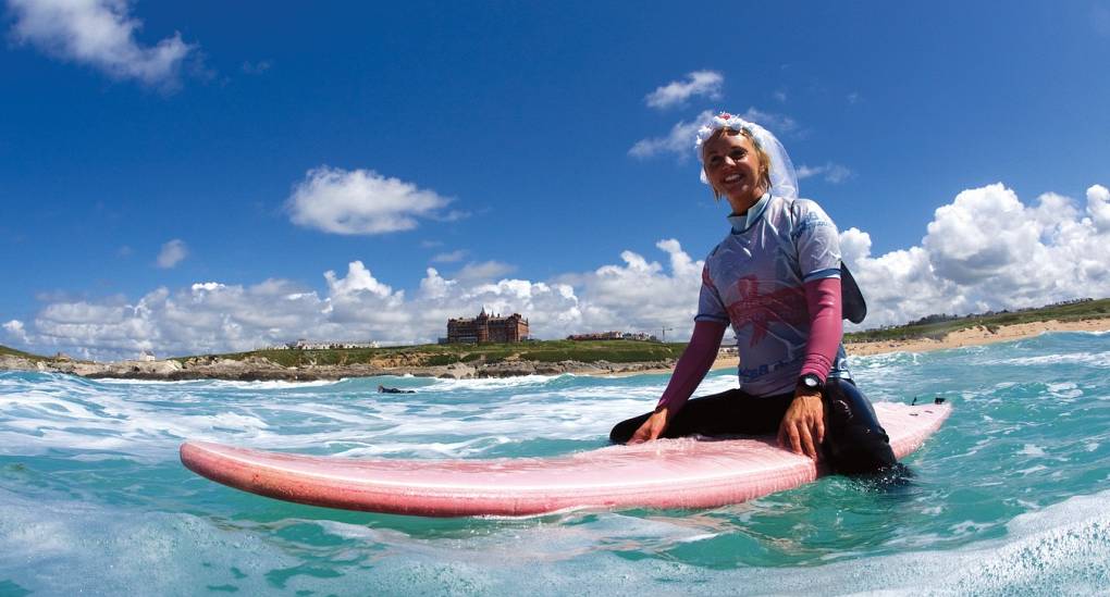 Hen in fancy dress ready to surf