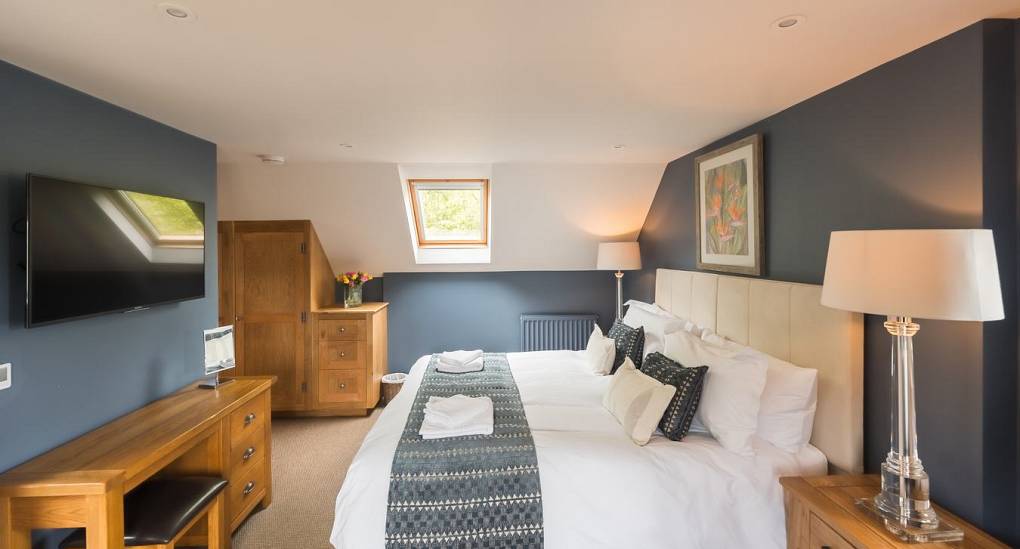 Large tv in bedroom with king size bed