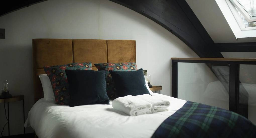Spacious bedroom at Lux Life Edinburgh with a large double bed and high ceilings, offering luxury Edinburgh city centre accommodation for large hen groups.