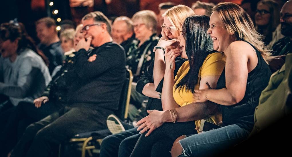 Audience members enjoying a comedy club