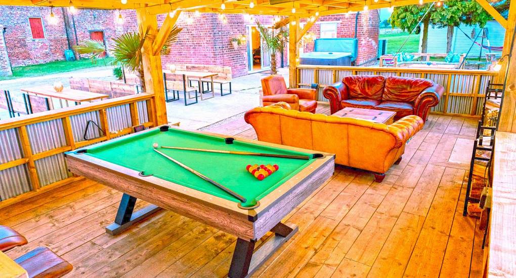The perfect outdoor living space with pool table and chill out zones at the Grange