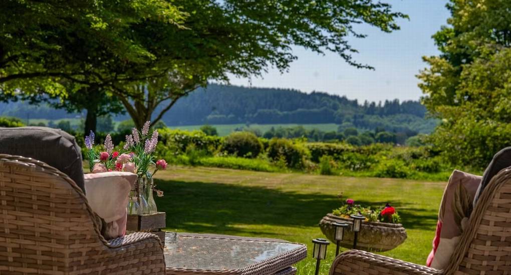 A view of the rolling Herefordshire countryside and private garden, as seen from the outdoor seating area at The Sash House.